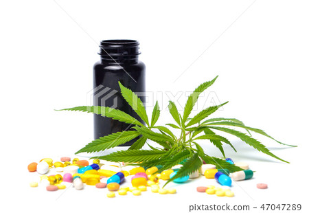 Marijuana leafs with medical pills isolated Marijuana leafs with medical pills isolated 47047289