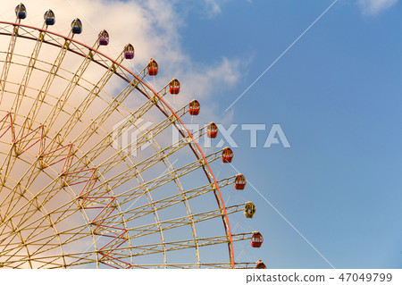 Modern ferris wheel with blue sky  47049799