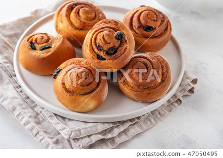 Freshly Baked Traditional Sweet Cinnamon Rolls, Swirl on white plate. Copy space. 47050495