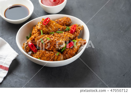 Chicken nuggets with sauce and pepper on a dark background. Copy space. Chicken nuggets with sauce and pepper on a dark background. Copy space. 47050712