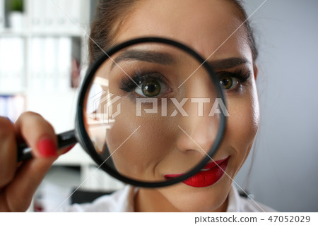 Funny smiling businesswoman hold in arm magnifier Funny smiling businesswoman hold in arm magnifier 47052029