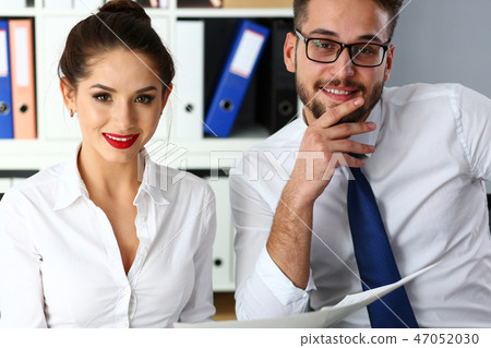 Couple positive funny clerks examine and discuss some public opinion 47052030