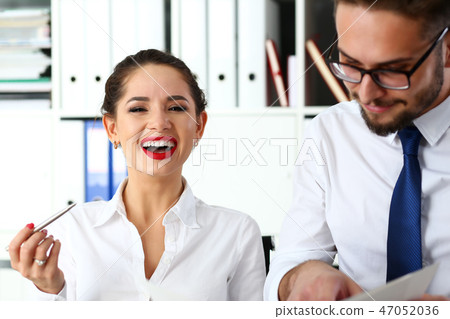 Couple positive funny clerks examine and discuss some public opinion Couple positive funny clerks examine and discuss some public opinion 47052036