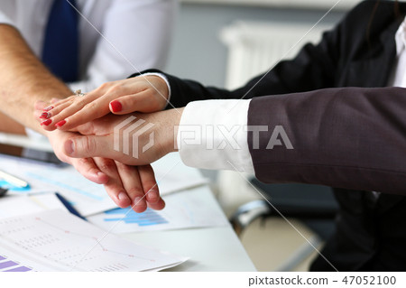 Group of people in suits crossed hands in pile Group of people in suits crossed hands in pile 47052100