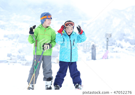 Children enjoying skiing 47052276