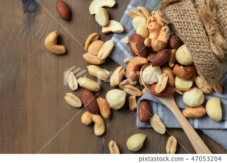 salted cocktail nuts on wood background, salted cocktail nuts on wood background, 47053204
