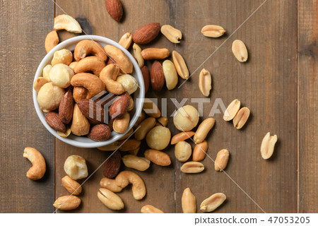 salted cocktail nuts in cup on wood salted cocktail nuts in cup on wood 47053205