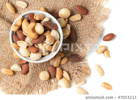 salted cocktail nuts in small cup isolated salted cocktail nuts in small cup isolated 47053211