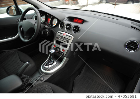 Modern luxury prestige car interior, dashboard, steering wheel. Black perforated leather interior. 47053681