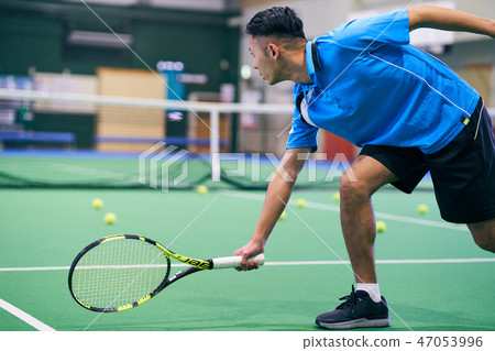 A man playing tennis 47053996