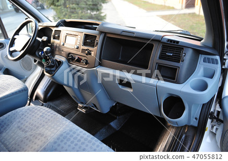 Modern luxury prestige car interior, dashboard, steering wheel. Black perforated leather interior. Modern luxury prestige car interior, dashboard, steering wheel. Black perforated leather interior. 47055812