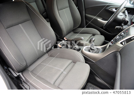 Modern luxury prestige car interior, dashboard, steering wheel. Black perforated leather interior. Modern luxury prestige car interior, dashboard, steering wheel. Black perforated leather interior. 47055813