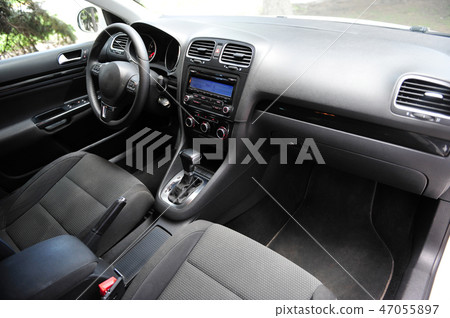 Modern luxury prestige car interior, dashboard, steering wheel. Black perforated leather interior. Modern luxury prestige car interior, dashboard, steering wheel. Black perforated leather interior. 47055897
