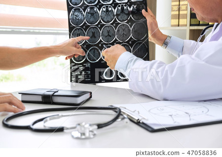 Professor Doctor having conversation with patient and holding x- 47058836