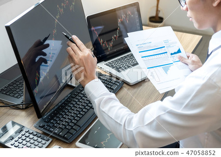 Stock exchange market concept, stock broker looking at graph wor Stock exchange market concept, stock broker looking at graph wor 47058852