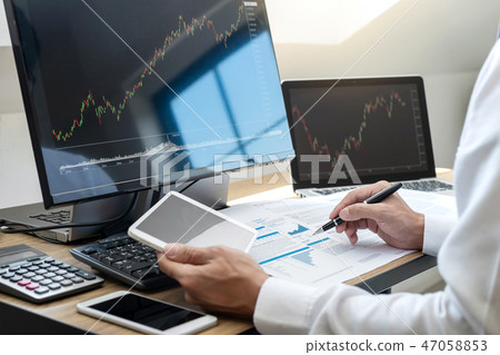Stock exchange market concept, stock broker looking at graph wor 47058853