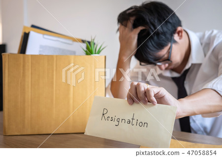 Stressed businessman will being resignation and packing belongin Stressed businessman will being resignation and packing belongin 47058854