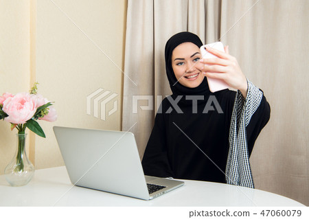 Beautiful young arabic woman taking selfie with her mobile phone 47060079