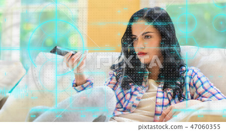 Young woman holding a TV remote control Young woman holding a TV remote control 47060355