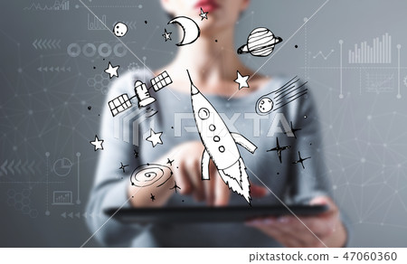 Dream of space and rocket with woman using a tablet Dream of space and rocket with woman using a tablet 47060360