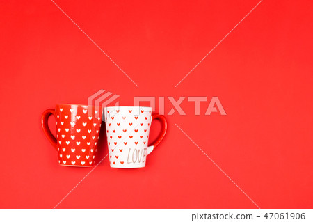 Couple of beautiful cups on red. 47061906