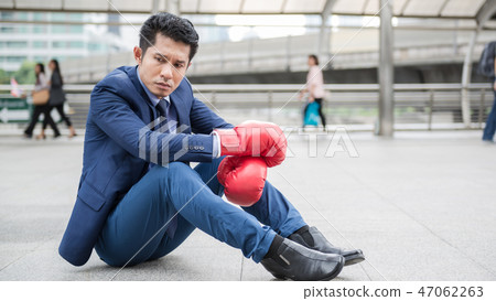 A man sit alone and tiring after fighting  47062263