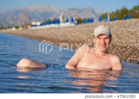 Happy man in sea Happy man in sea 47062895