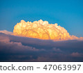 Cumulonimbus illuminated by the setting sun 47063997