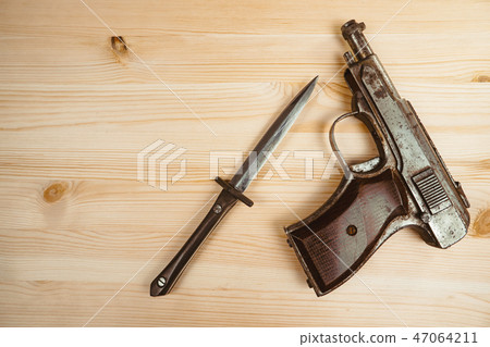 the gun is on the table 47064211