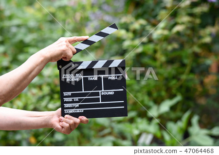 A hand with clapperboard A hand with clapperboard 47064468