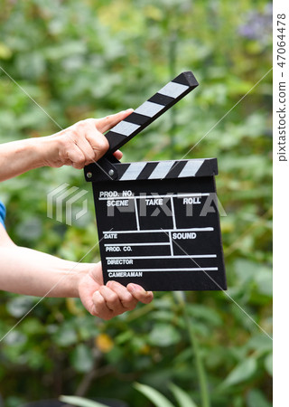 A hand with clapperboard A hand with clapperboard 47064478