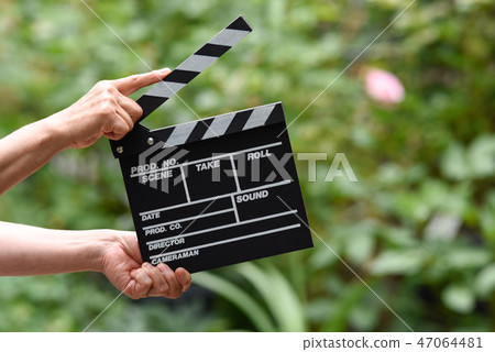 A hand with clapperboard A hand with clapperboard 47064481