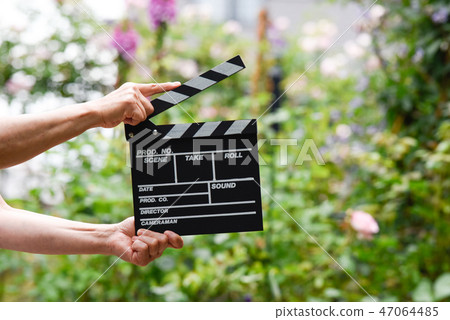 A hand with clapperboard A hand with clapperboard 47064485