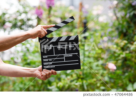 A hand with clapperboard A hand with clapperboard 47064486