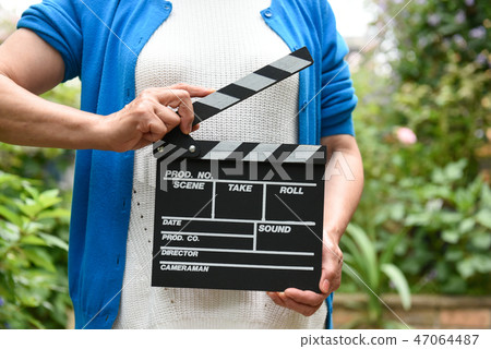 A hand with clapperboard A hand with clapperboard 47064487
