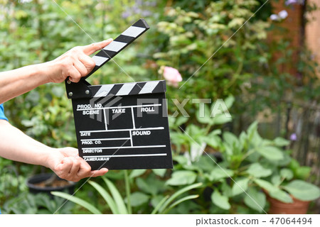 A hand with clapperboard A hand with clapperboard 47064494