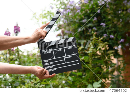 A hand with clapperboard A hand with clapperboard 47064502