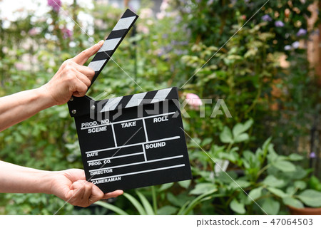 A hand with clapperboard A hand with clapperboard 47064503