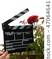 A hand with clapperboard 47064641