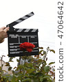 A hand with clapperboard 47064642