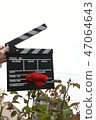 A hand with clapperboard 47064643