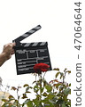 A hand with clapperboard 47064644