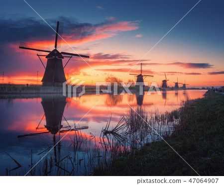 Windmills at beautiful sunrise in Netherlands Windmills at beautiful sunrise in Netherlands 47064907