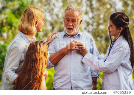 Happy healthy family and doctor talking in park. Happy healthy family and doctor talking in park. 47065229