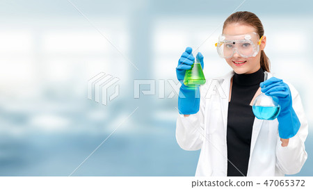 Scientist or chemist holds test tube in laboratory 47065372
