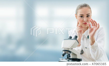 Scientist researcher uses microscope in laboratory Scientist researcher uses microscope in laboratory 47065385
