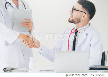 Doctor at hospital shakes hand with another doctor 47065402