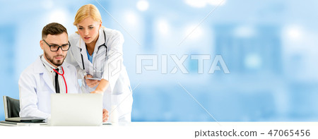 Doctors working with laptop computer in hospital. Doctors working with laptop computer in hospital. 47065456
