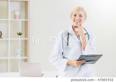 Young female doctor working in hospital office. Young female doctor working in hospital office. 47065558