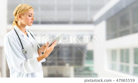 Doctor using tablet computer at the hospital. Doctor using tablet computer at the hospital. 47065559